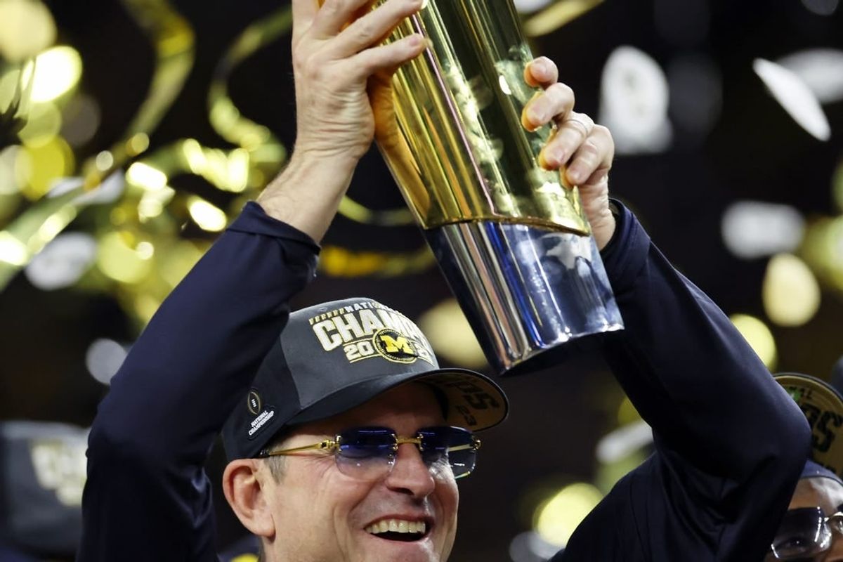 Jan 8, 2024; Houston, TX, USA; Michigan Wolverines head coach Jim Harbaugh holds the National Championship Trophy as he celebrates after winning 2024 College Football Playoff national championship game against the Washington Huskies at NRG Stadium.