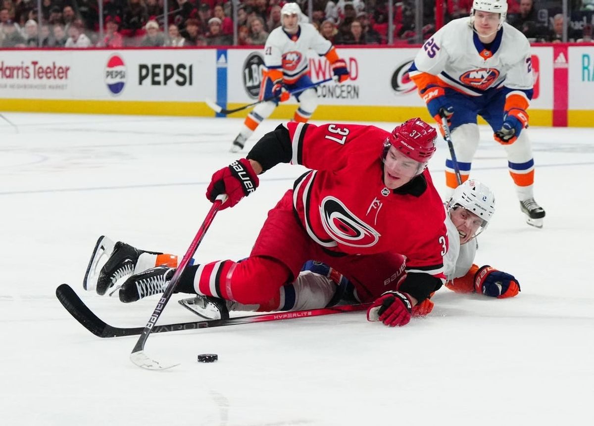Dec 23, 2023; Raleigh, North Carolina, USA; Carolina Hurricanes right wing Andrei Svechnikov (37) is knocked off the puck during the first period at PNC Arena.