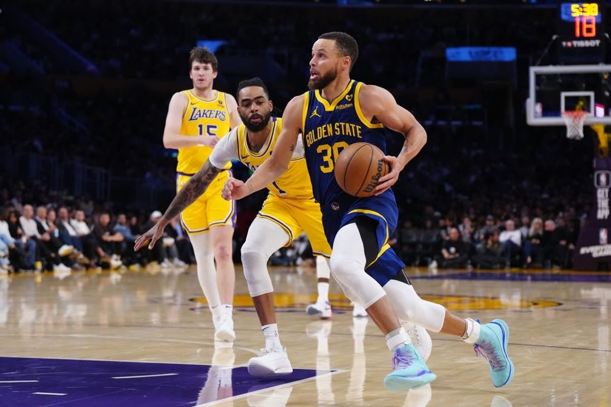 Apr 9, 2024; Los Angeles, California, USA; Golden State Warriors guard Stephen Curry (30) drives to the basket against Los Angeles Lakers guard D'Angelo Russell (1) in the second half at Crypto.com Arena.