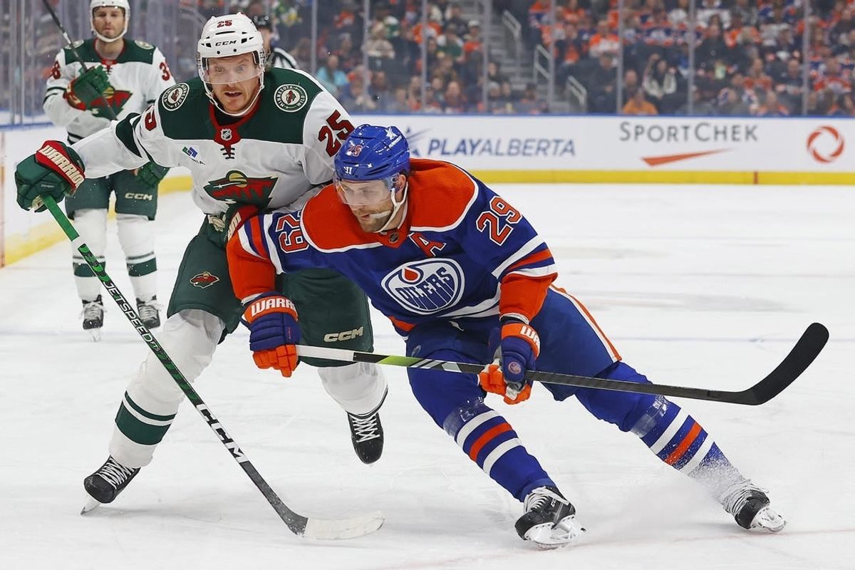 Dec 8, 2023; Edmonton, Alberta, CAN; Minnesota Wild defensemen Jonas Brodin (25) and Edmonton Oilers forward Leon Draisaitl (29) battles for position during the first period at Rogers Place.