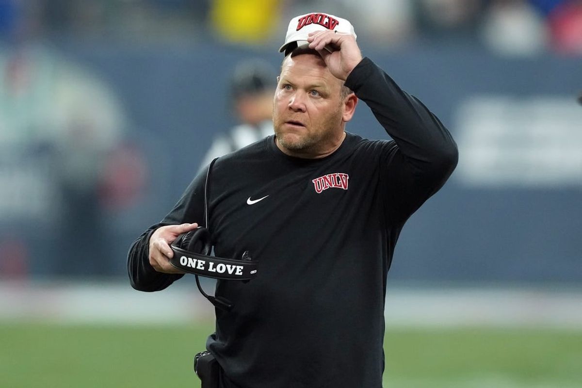 Dec 26, 2023; Phoenix, AZ, USA; UNLV Rebels head coach Barry Odom reacts against the Kansas Jayhawks during the first half at Chase Field.