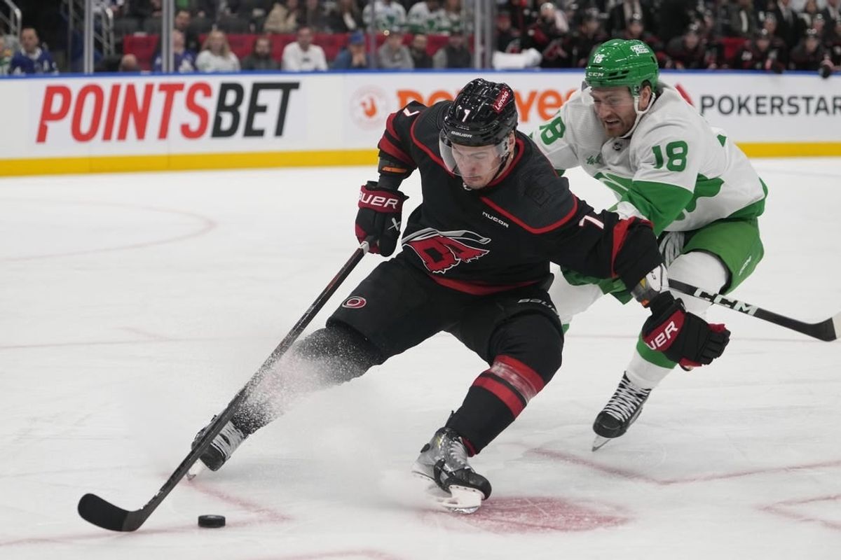 Mar 16, 2024; Toronto, Ontario, CAN; Carolina Hurricanes defenseman Dmitry Orlov (7) controls the puck against Toronto Maple Leafs forward Noah Gregor (18) during the third period at Scotiabank Arena.