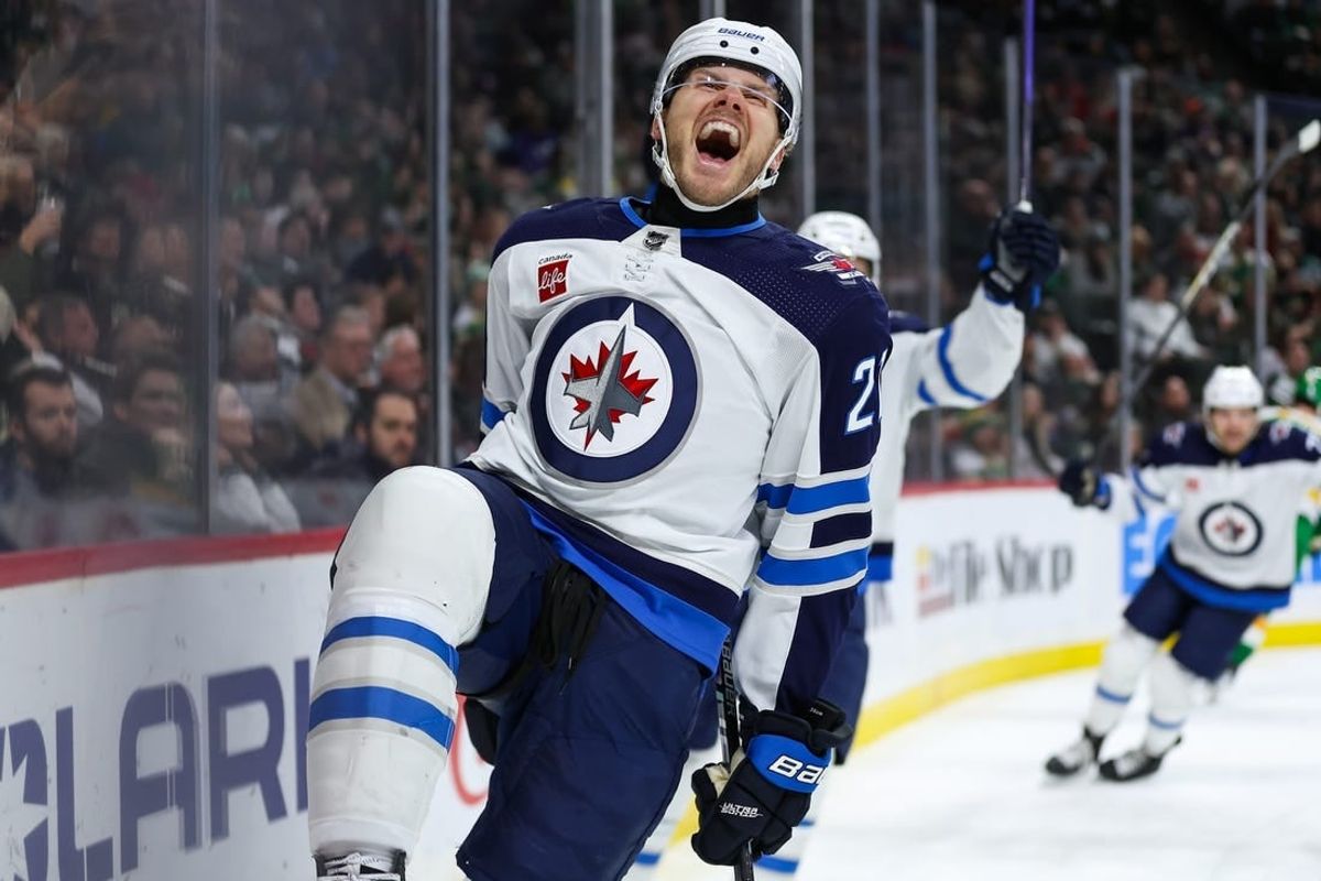Dec 31, 2023; Saint Paul, Minnesota, USA; Winnipeg Jets center Dominic Toninato (21) celebrates his goal against the Minnesota Wild during the third period at Xcel Energy Center.