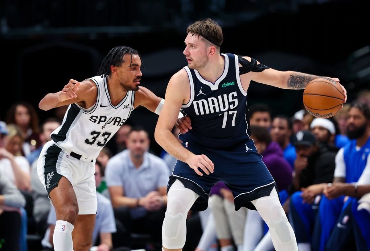 Dec 23, 2023; Dallas, Texas, USA; Dallas Mavericks guard Luka Doncic (77) controls the ball as San Antonio Spurs guard Tre Jones (33) defends during the second quarter at American Airlines Center.