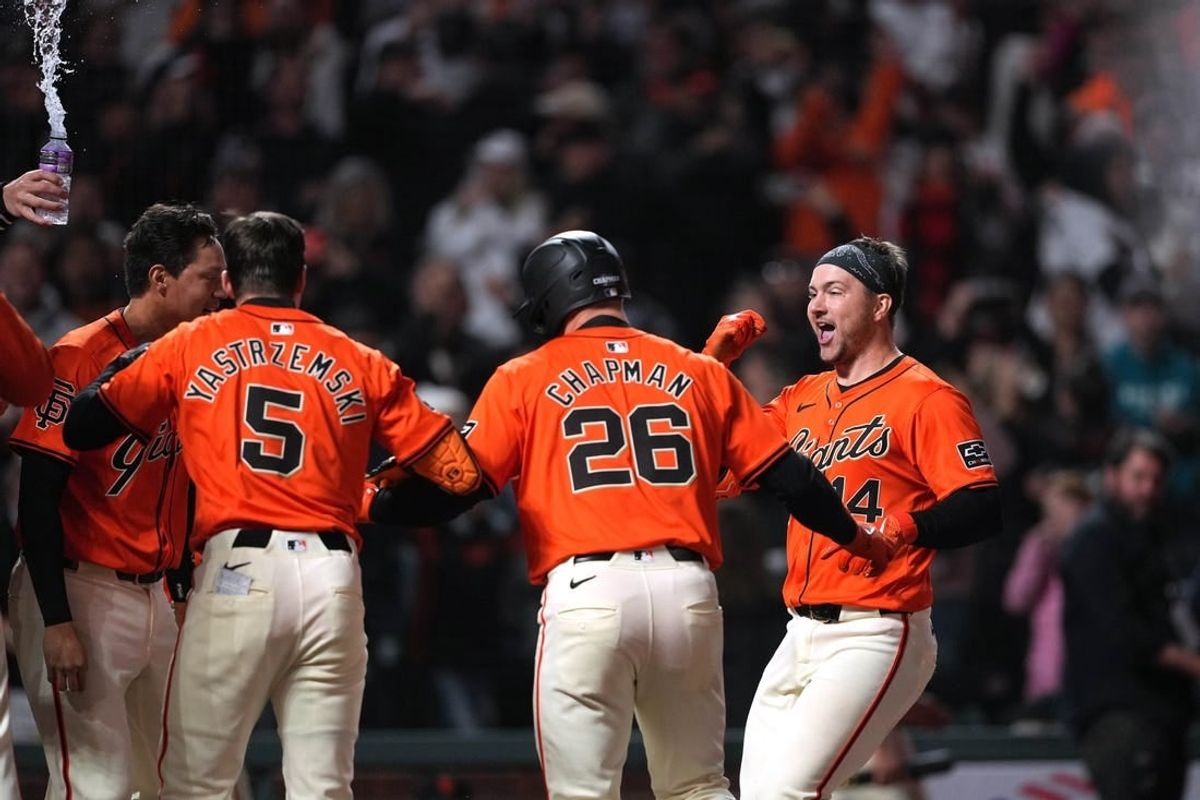 Apr 26, 2024; San Francisco, California, USA; San Francisco Giants catcher Patrick Bailey (14) reaches home plate after hitting a walk-off home run as teammates wait to celebrate during the ninth inning against the Pittsburgh Pirates at Oracle Park.