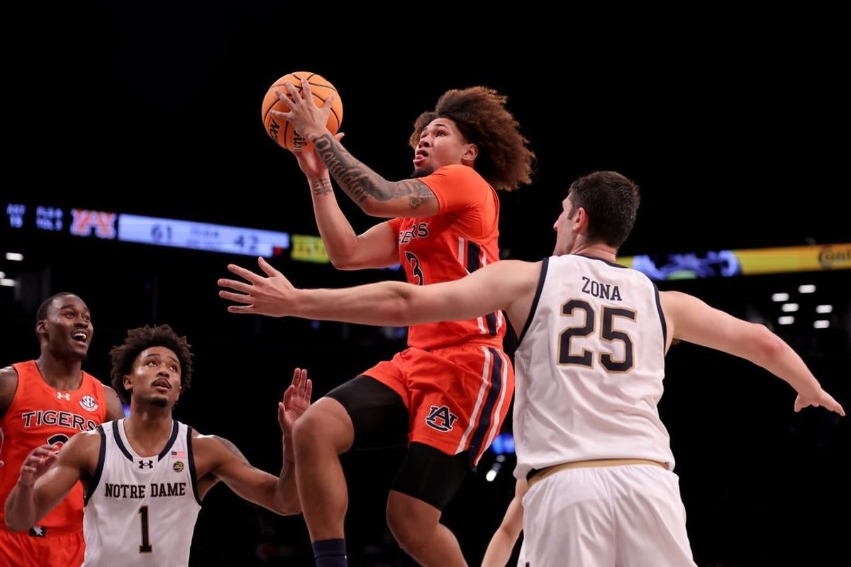 Nov 16, 2023; Brooklyn, New York, USA; Auburn Tigers guard Tre Donaldson (3) drives to the basket against Notre Dame Fighting Irish guard Julian Roper II (1) and forward Matt Zona (25) during the second half at Barclays Center.