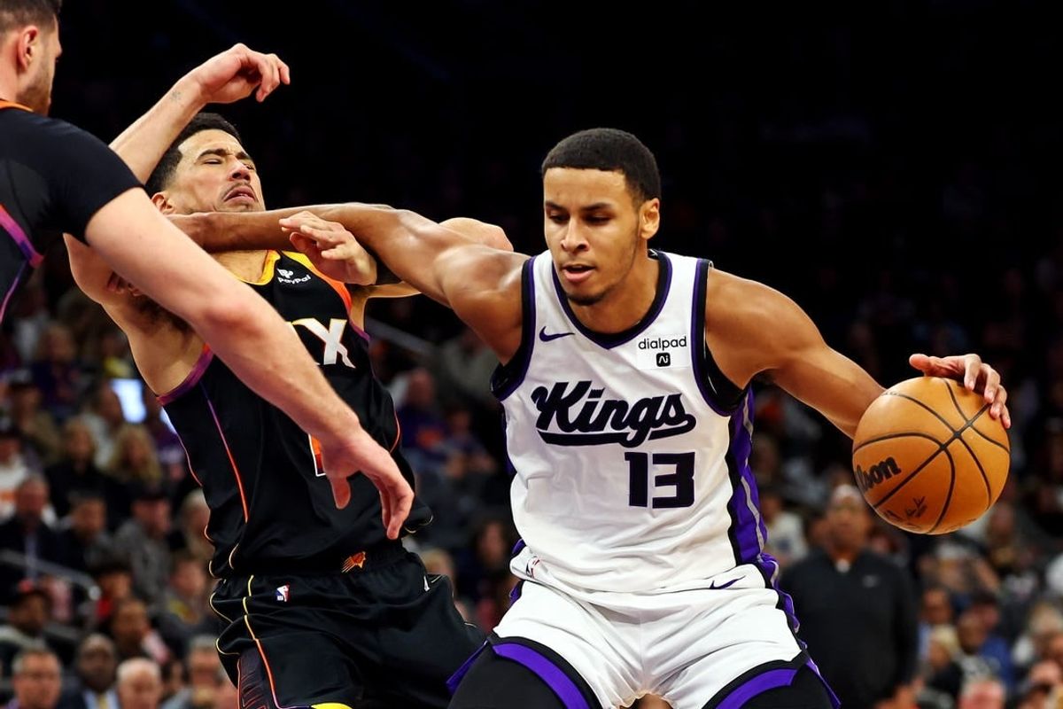Jan 16, 2024; Phoenix, Arizona, USA; Sacramento Kings forward Keegan Murray (13) drives to the basket against Phoenix Suns guard Devin Booker (1) during the third quarter at Footprint Center.