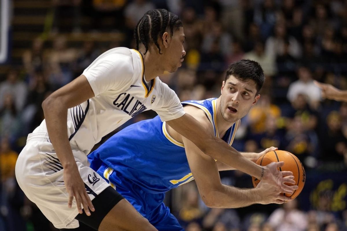 Feb 10, 2024; Berkeley, California, USA; UCLA Bruins guard Lazar Stefanovic (right) looks to pass around California Golden Bears guard Rodney Brown Jr. (1) during the first half at Haas Pavilion.