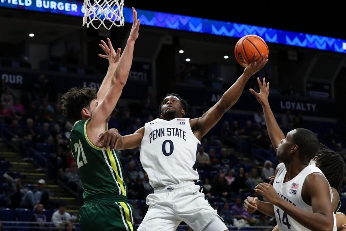 Dec 21, 2023; University Park, Pennsylvania, USA; Penn State Nittany Lions guard Kanye Clary (0) drives the ball to the basket as Le Moyne Dolphins guard Trent Mosquera (21) defends during the first half at Bryce Jordan Center.