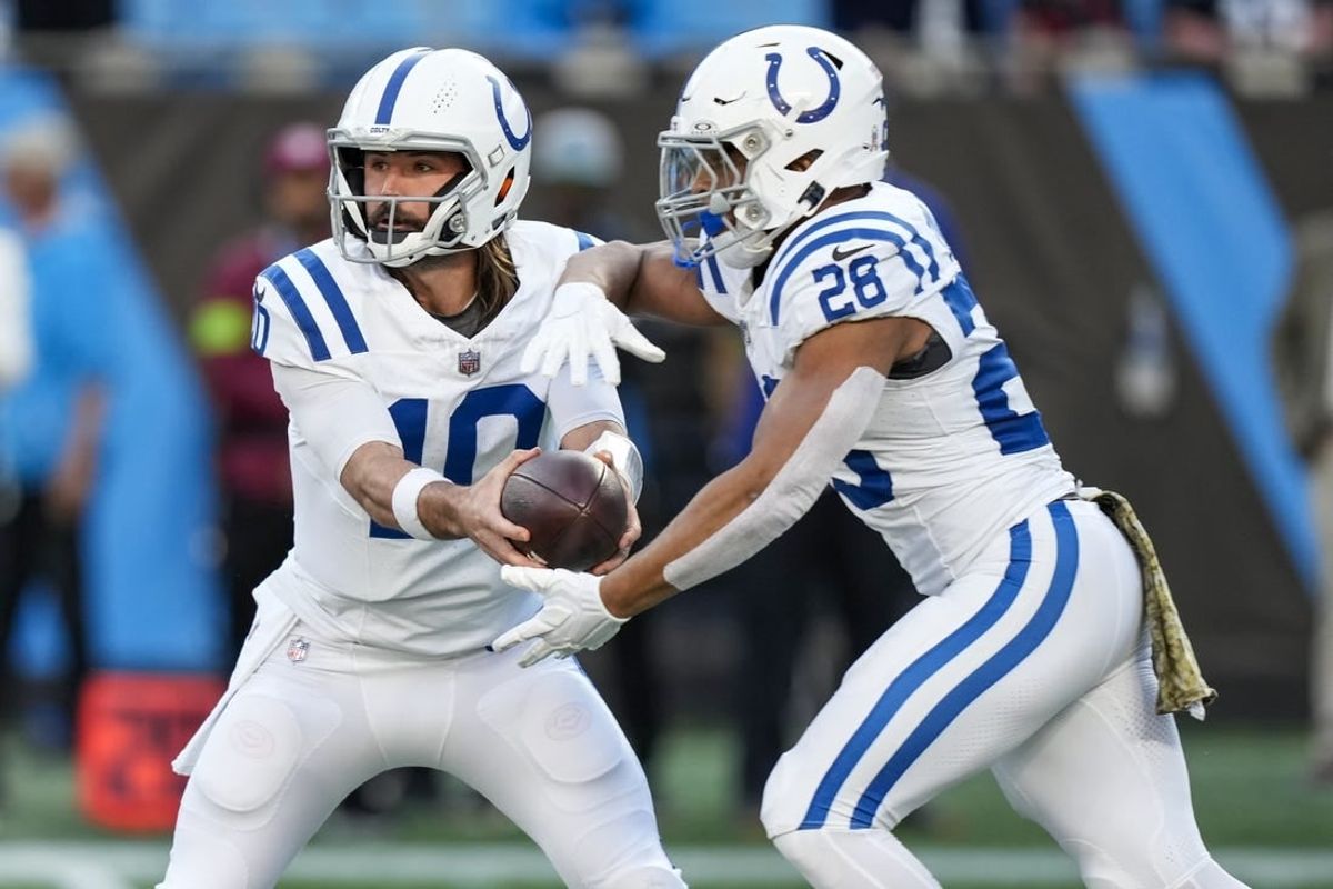 Nov 5, 2023; Charlotte, North Carolina, USA; Indianapolis Colts quarterback Gardner Minshew (10) hands off to running back Jonathan Taylor (28) during the first quarter against the Carolina Panthers at Bank of America Stadium.