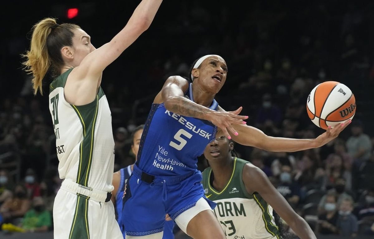 Aug 12, 2021; Phoenix, Arizona, USA; Connecticut Sun guard Jasmine Thomas (5) drives against Seattle Storm forward Breanna Stewart (30) in the second half during the Inaugural WNBA Commissioners Cup Championship Game at Footprint Center.