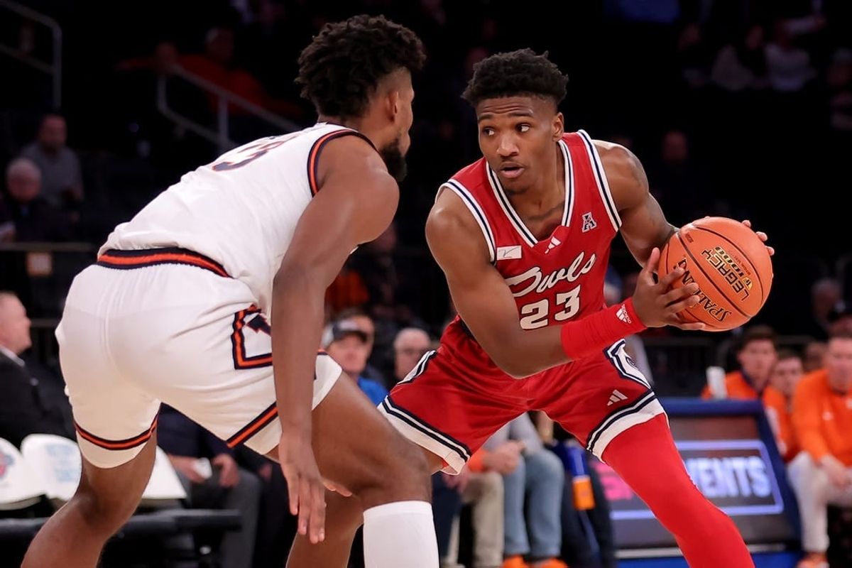 Dec 5, 2023; New York, New York, USA; Florida Atlantic Owls guard Brandon Weatherspoon (23) controls the ball against Illinois Fighting Illini forward Quincy Guerrier (13) during the second half at Madison Square Garden.