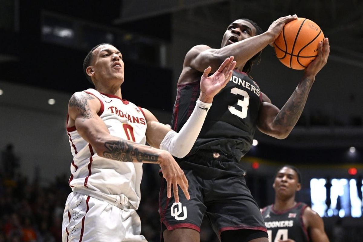 Nov 24, 2023; La Jolla, California, USA; Oklahoma Sooners guard Otega Oweh (3) goes to the basket while defended by USC Trojans guard Kobe Johnson (0) during the second half at LionTree Arena.