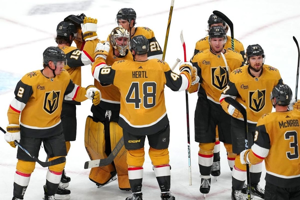 Apr 12, 2024; Las Vegas, Nevada, USA; Vegas Golden Knights players celebrate after defeating the Minnesota Wild 7-2 to clench the final playoff position in the Western Conference at T-Mobile Arena.