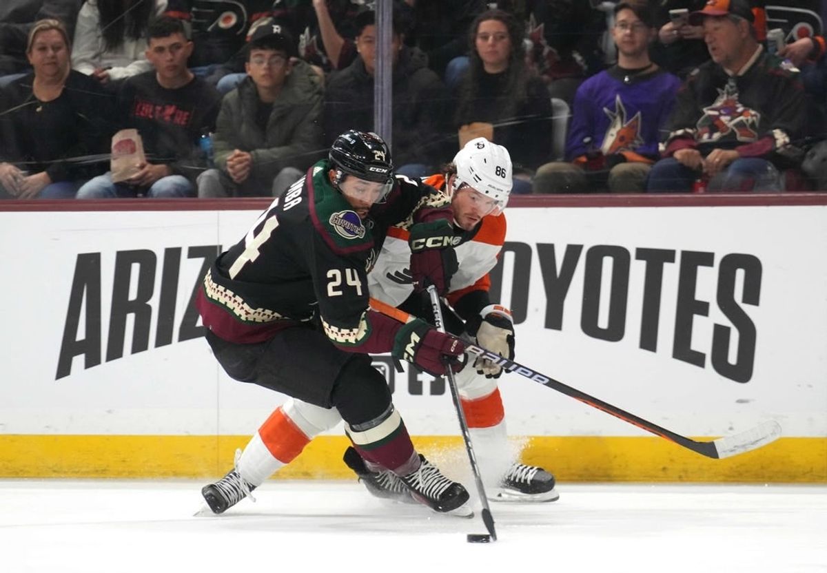 Dec 7, 2023; Tempe, Arizona, USA; Arizona Coyotes defenseman Matt Dumba (24) and Philadelphia Flyers left wing Joel Farabee (86) battle for the puck during the first period at Mullett Arena.