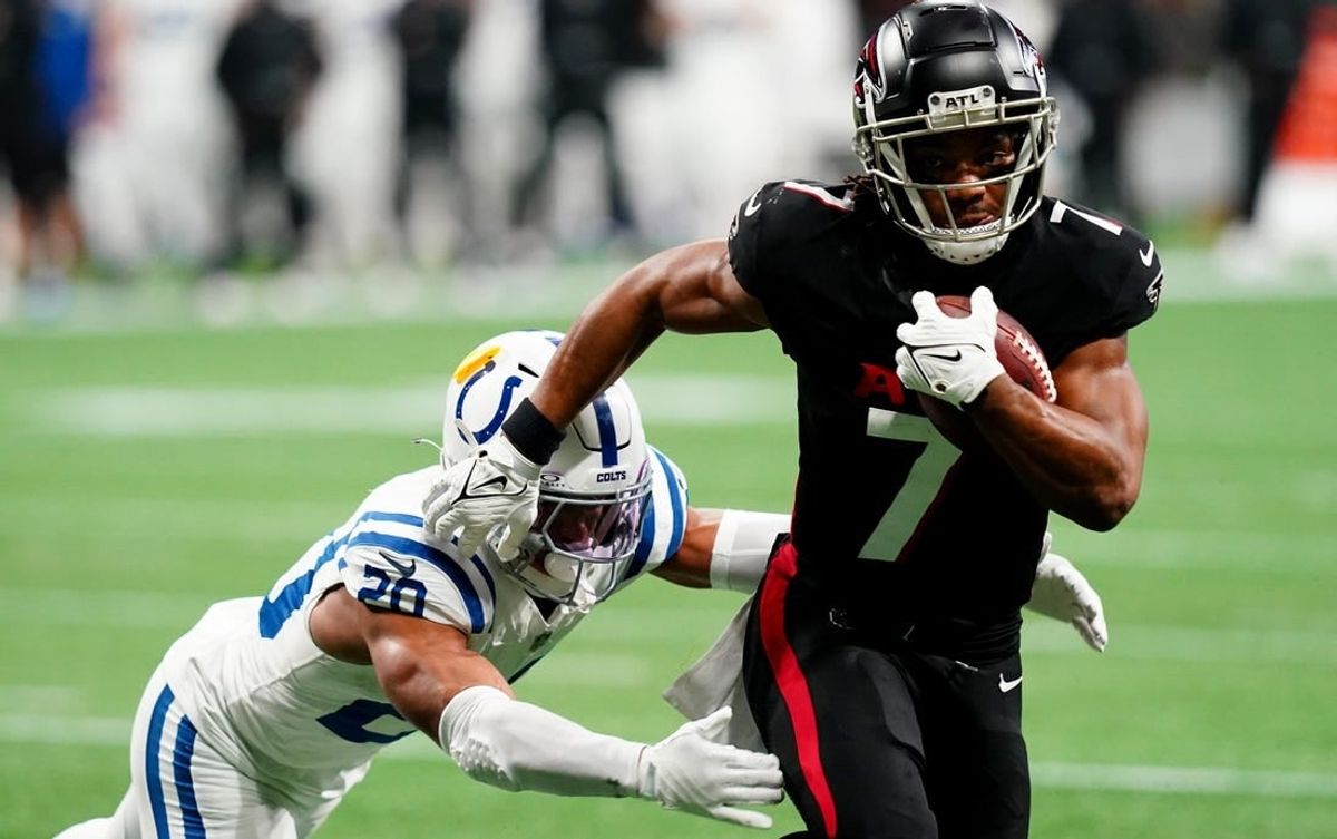 Dec 24, 2023; Atlanta, Georgia, USA; Atlanta Falcons running back Bijan Robinson (7) carries the ball against Indianapolis Colts safety Nick Cross (20) during the first half at Mercedes-Benz Stadium.