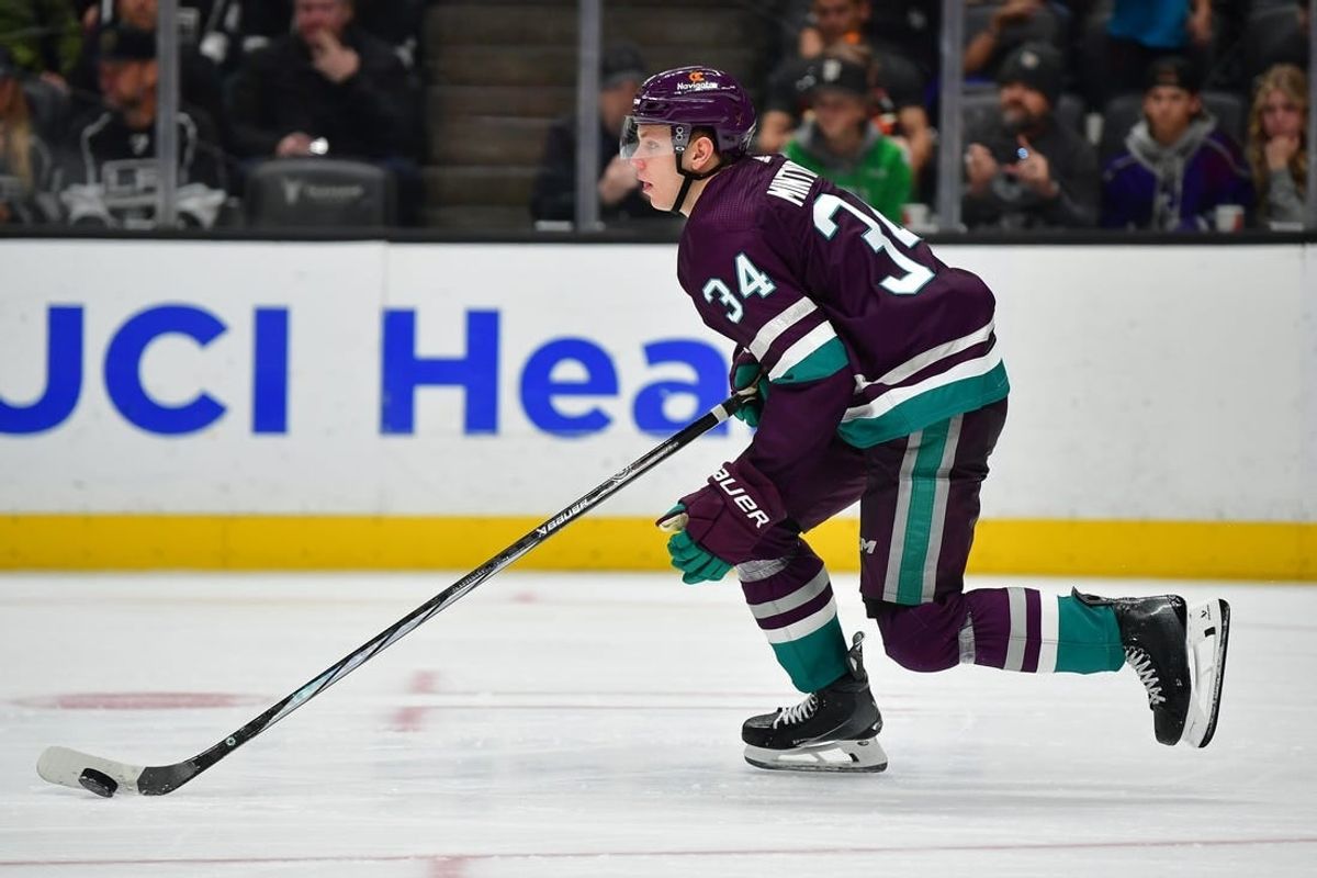 Nov 24, 2023; Anaheim, California, USA; Anaheim Ducks defenseman Pavel Mintyukov (34) moves the puck against the Los Angeles Kings during the third period at Honda Center.
