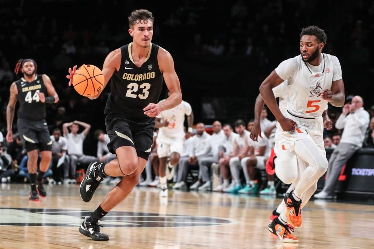 Dec 10, 2023; Brooklyn, New York, USA;  Colorado Buffaloes forward Tristan da Silva (23) and Miami (Fl) Hurricanes guard Wooga Poplar (5) at Barclays Center.