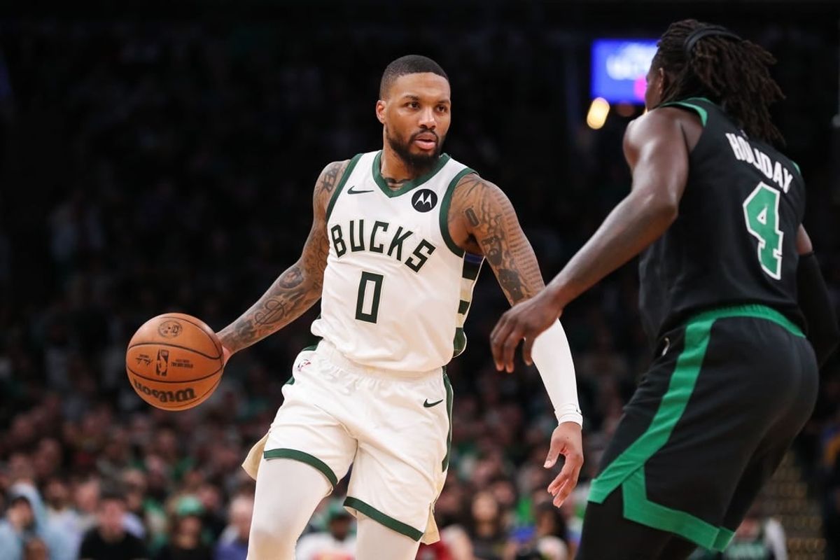 Nov 22, 2023; Boston, Massachusetts, USA; Milwaukee Bucks guard Damian Lillard (0) dribbles down the court during the second half against the Boston Celtics at TD Garden.