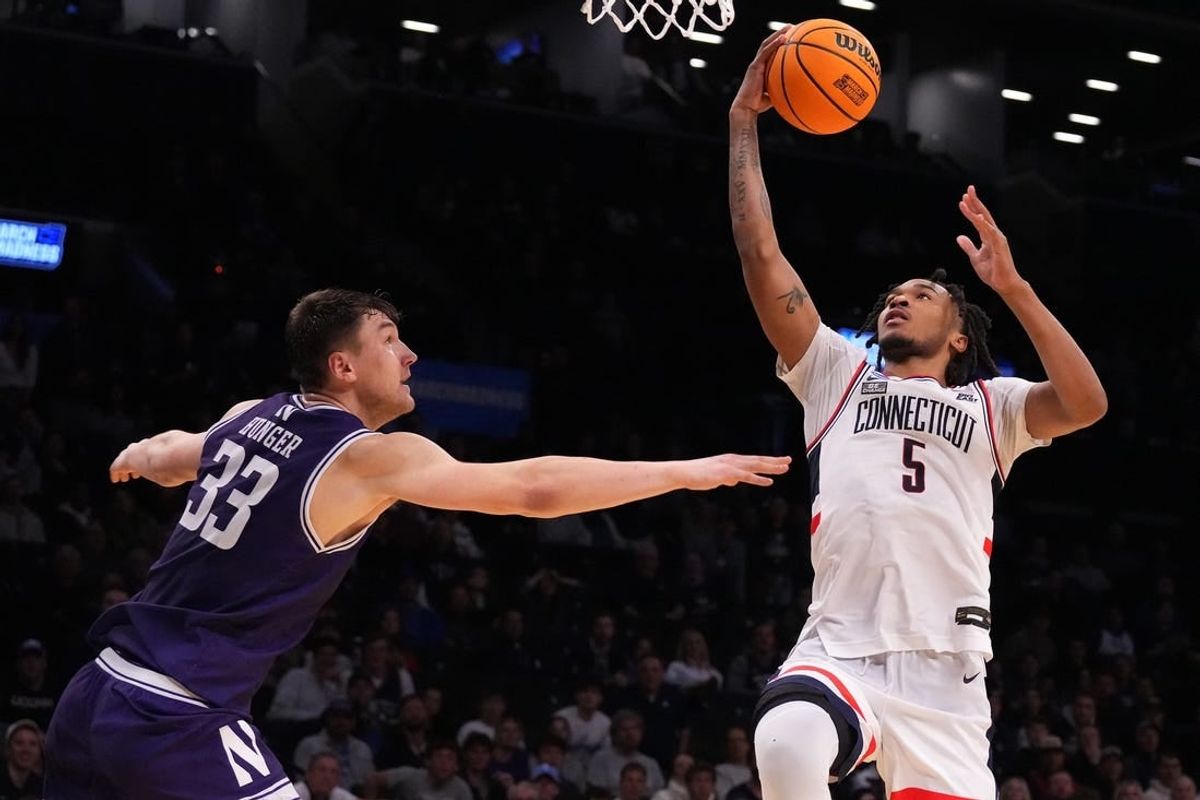 Mar 24, 2024; Brooklyn, NY, USA; Connecticut Huskies guard Stephon Castle (5) shoots the ball over Northwestern Wildcats forward Luke Hunger (33) in the second round of the 2024 NCAA Tournament at the Barclays Center.