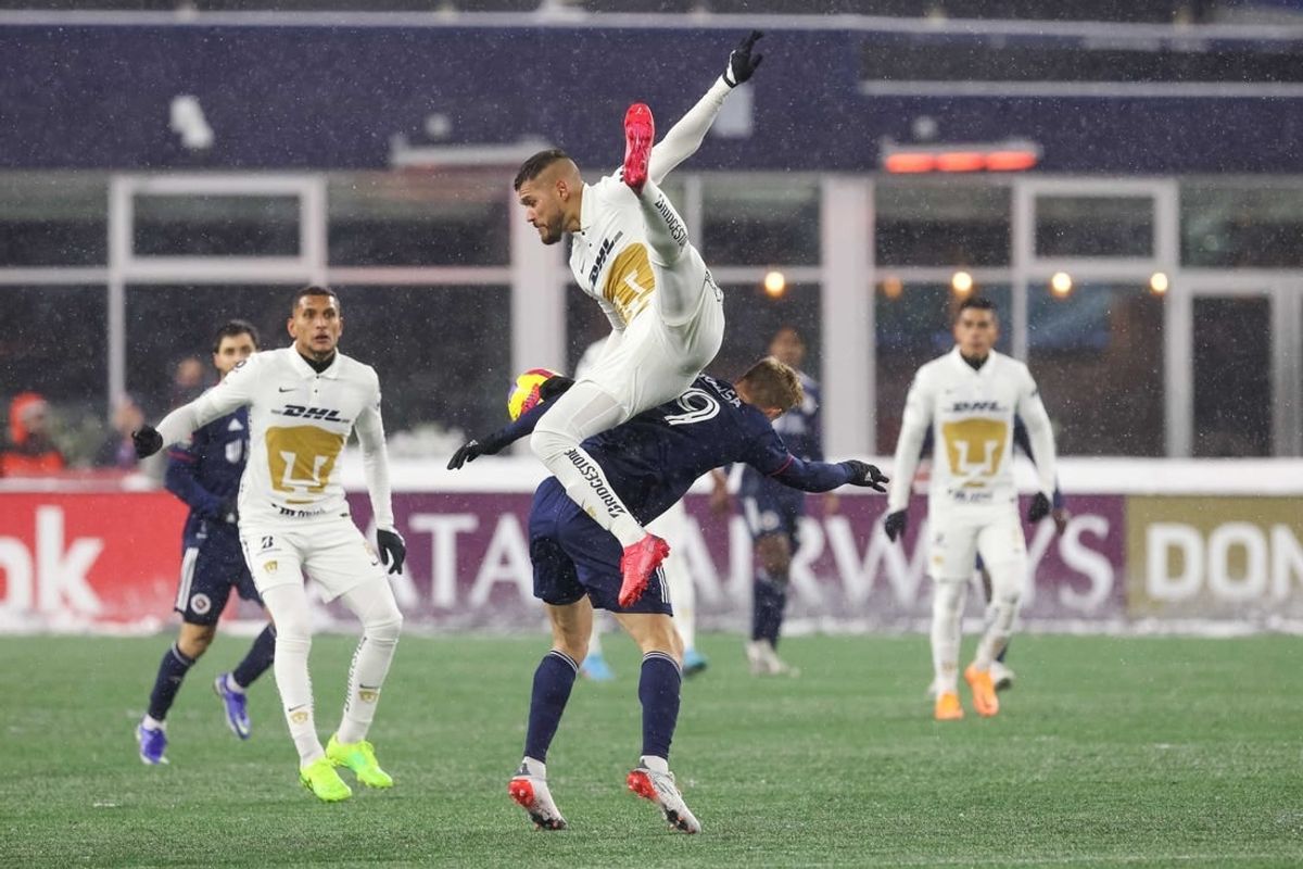 Mar 9, 2022; Foxborough, Massachusetts, USA; Pumas UNAM defender Nicolas Freire (23) heads the ball over New England Revolution forward Adam Buksa (9) during the second half at Gillette Stadium during the 2022 CONCACAF Champions League Quarterfinals.