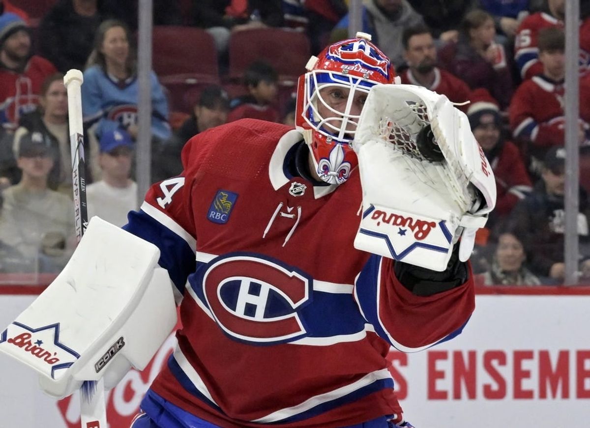 Feb 11, 2024; Montreal, Quebec, CAN; Montreal Canadiens goalie Jake Allen (34) makes a glove save during the first period of the game against the St.Louis Blues at the Bell Centre.
