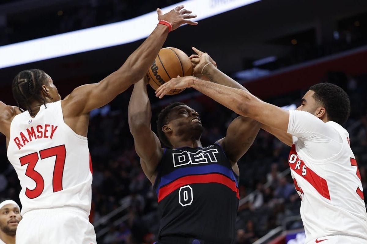 Mar 13, 2024; Detroit, Michigan, USA;  Detroit Pistons center Jalen Duren (0) grabs the rebound over Toronto Raptors guard Jahmi'us Ramsey (37) in the first half at Little Caesars Arena.