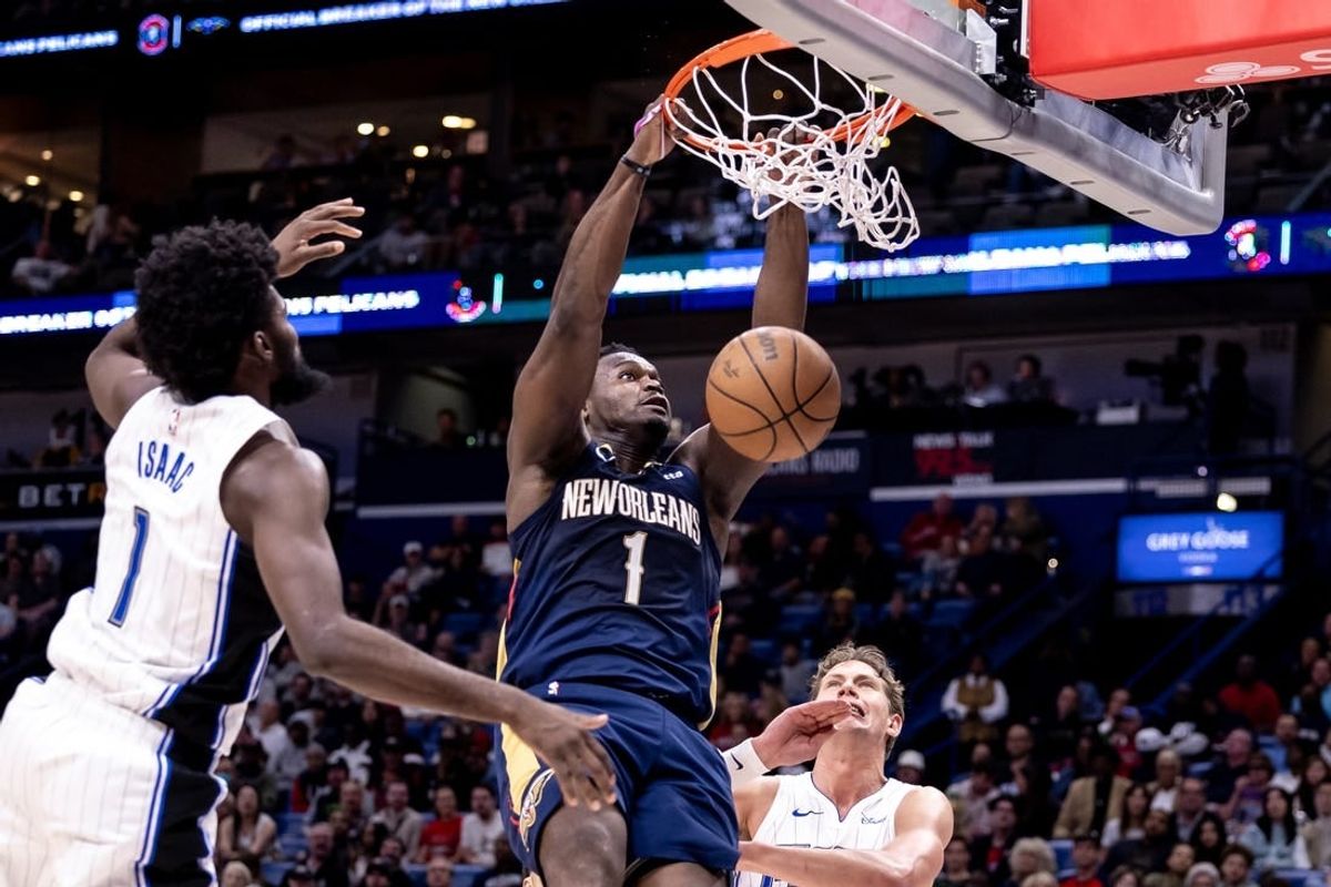 Apr 3, 2024; New Orleans, Louisiana, USA;  New Orleans Pelicans forward Zion Williamson (1) dunks the ball against Orlando Magic forward Jonathan Isaac (1) during the second half at Smoothie King Center.