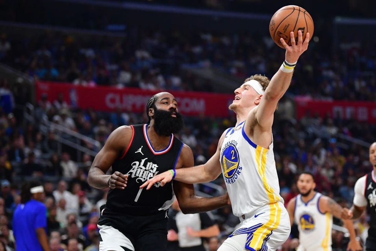 Dec 2, 2023; Los Angeles, California, USA; Golden State Warriors guard Brandin Podziemski (2) moves to the basket against Los Angeles Clippers guard James Harden (1) during the first half at Crypto.com Arena.