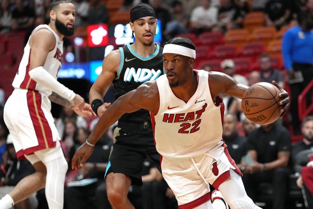 Dec 2, 2023; Miami, Florida, USA;  Miami Heat forward Jimmy Butler (22) grabs a rebound against the Indiana Pacers during the first half at Kaseya Center.