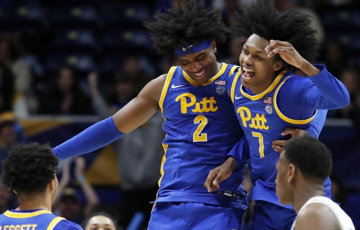 Feb 17, 2024; Pittsburgh, Pennsylvania, USA;  Pittsburgh Panthers forward Blake Hinson (2) and guard Carlton Carrington (7) celebrate after Hinson hit a three point basket to break the forty point mark against the Louisville Cardinals during the second half at the Petersen Events Center. Pittsburgh won 86-59.
