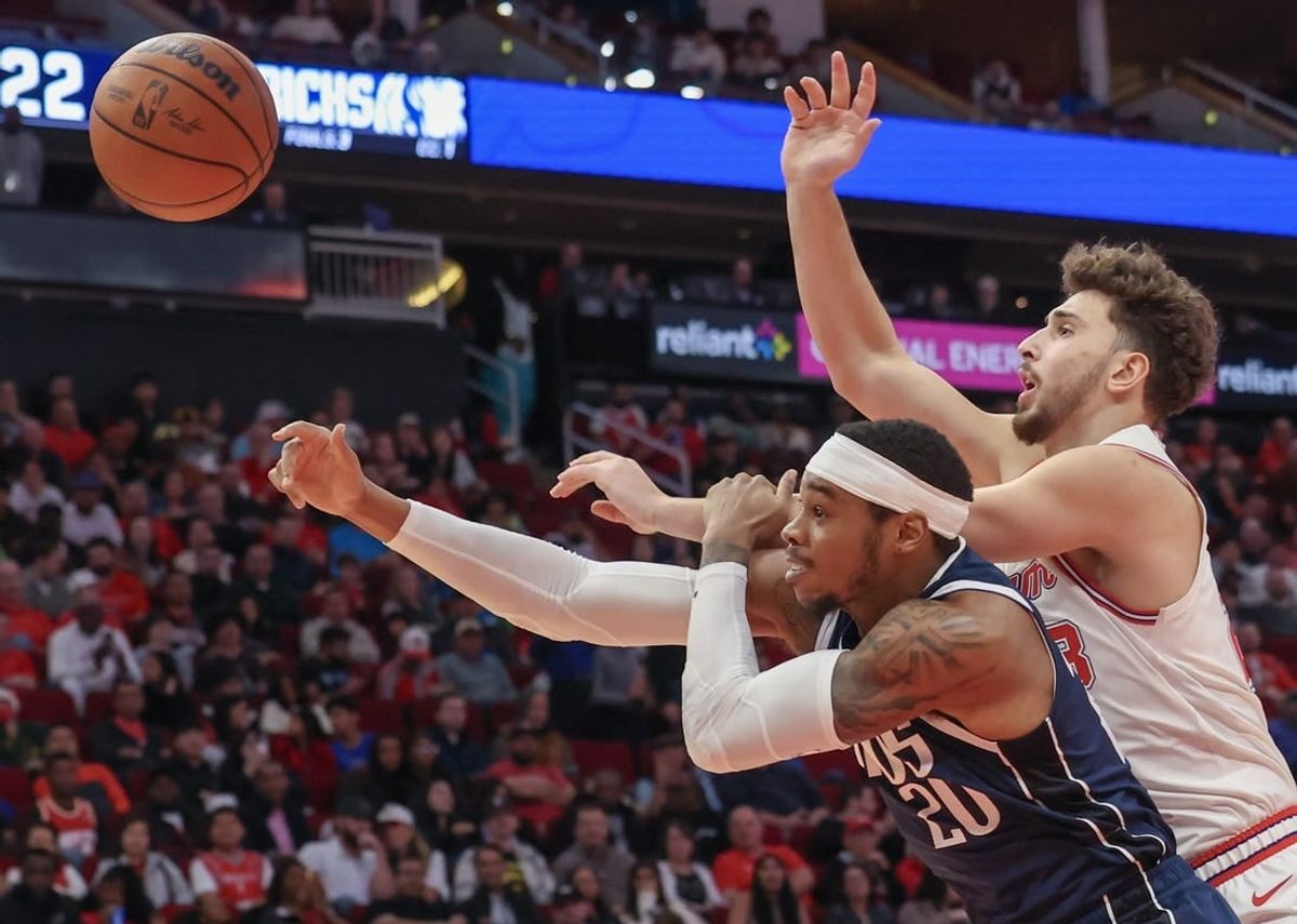 Dec 22, 2023; Houston, Texas, USA; Houston Rockets center Alperen Sengun (28) and Dallas Mavericks forward Richaun Holmes (20) reach for a rebound in the second quarter at Toyota Center.