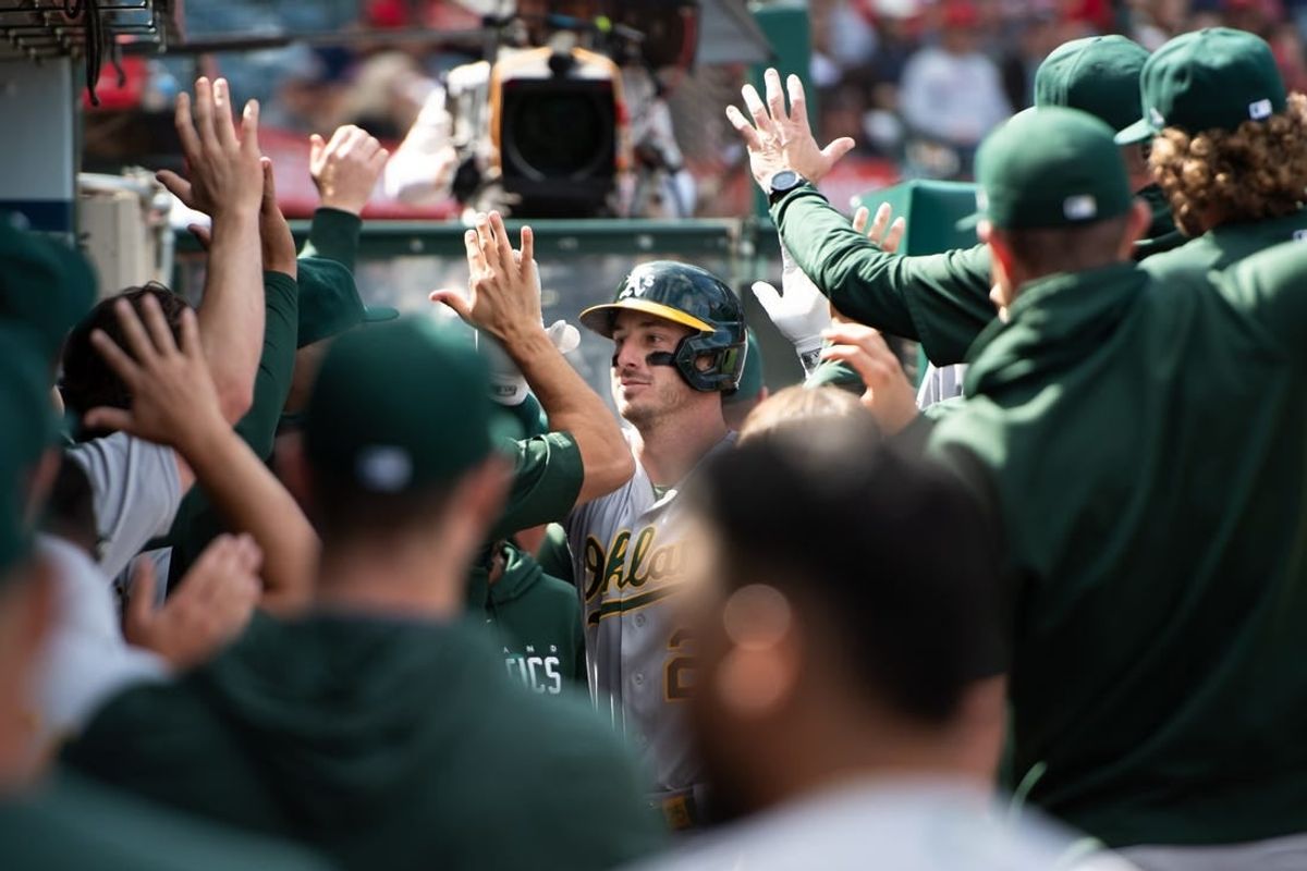 Oct 1, 2023; Anaheim, California, USA; Oakland Athletics designated hitter Brent Rooker (25) celebrates with teammates in the dugout after hitting a home run against the Los Angeles Angels during the eighth inning at Angel Stadium.