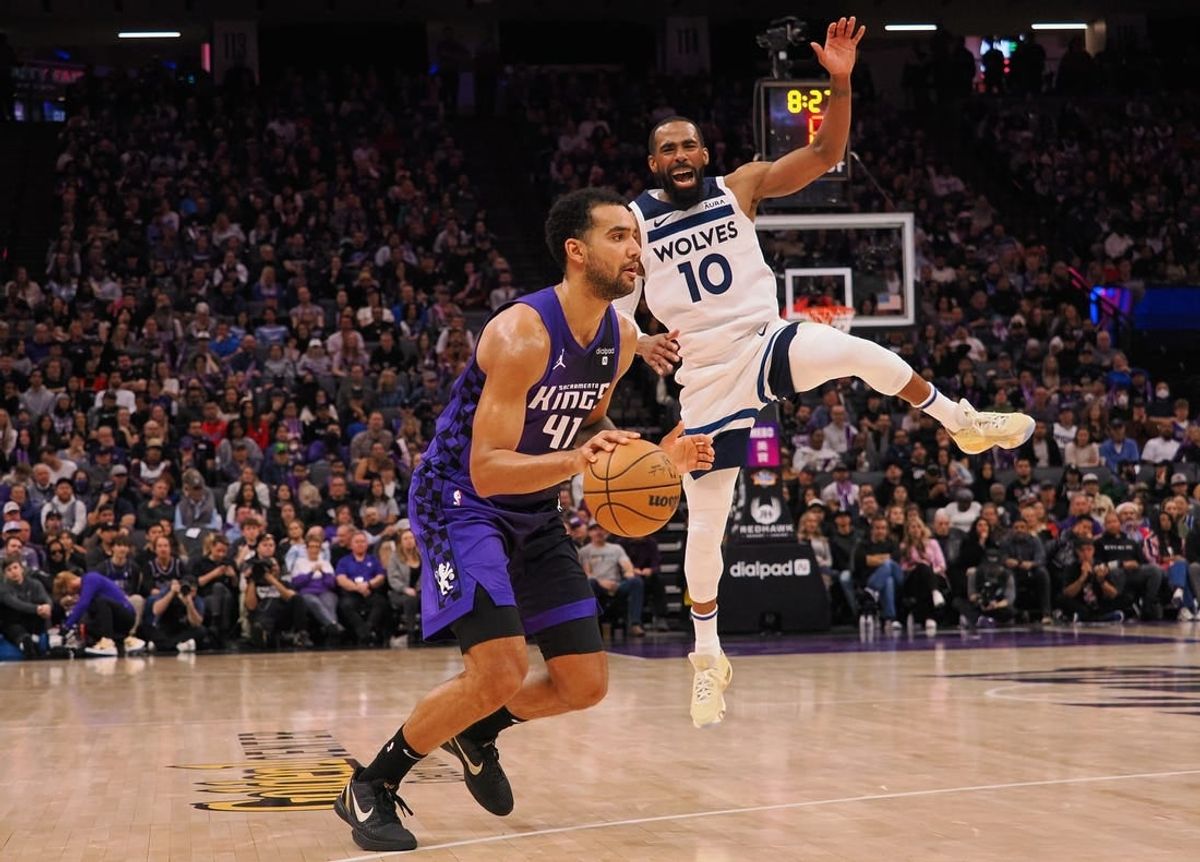 Dec 23, 2023; Sacramento, California, USA; Sacramento Kings forward Trey Lyles (41) controls the ball against Minnesota Timberwolves guard Mike Conley (10) during the fourth quarter at Golden 1 Center.