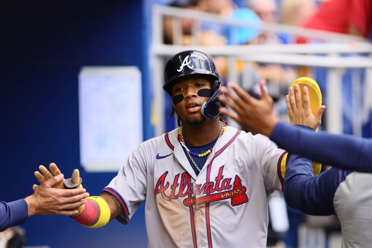 Apr 14, 2024; Miami, Florida, USA; Atlanta Braves right fielder Ronald Acuña Jr. (13) celebrates after scoring against the Miami Marlins during the third inning at loanDepot Park.