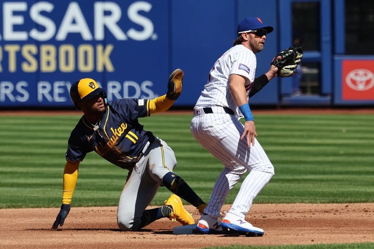 Mar 29, 2024; New York City, New York, USA; Milwaukee Brewers right fielder Jackson Chourio (11) calls for time after stealing second base behind New York Mets second baseman Jeff McNeil (1) before the game at Citi Field.
