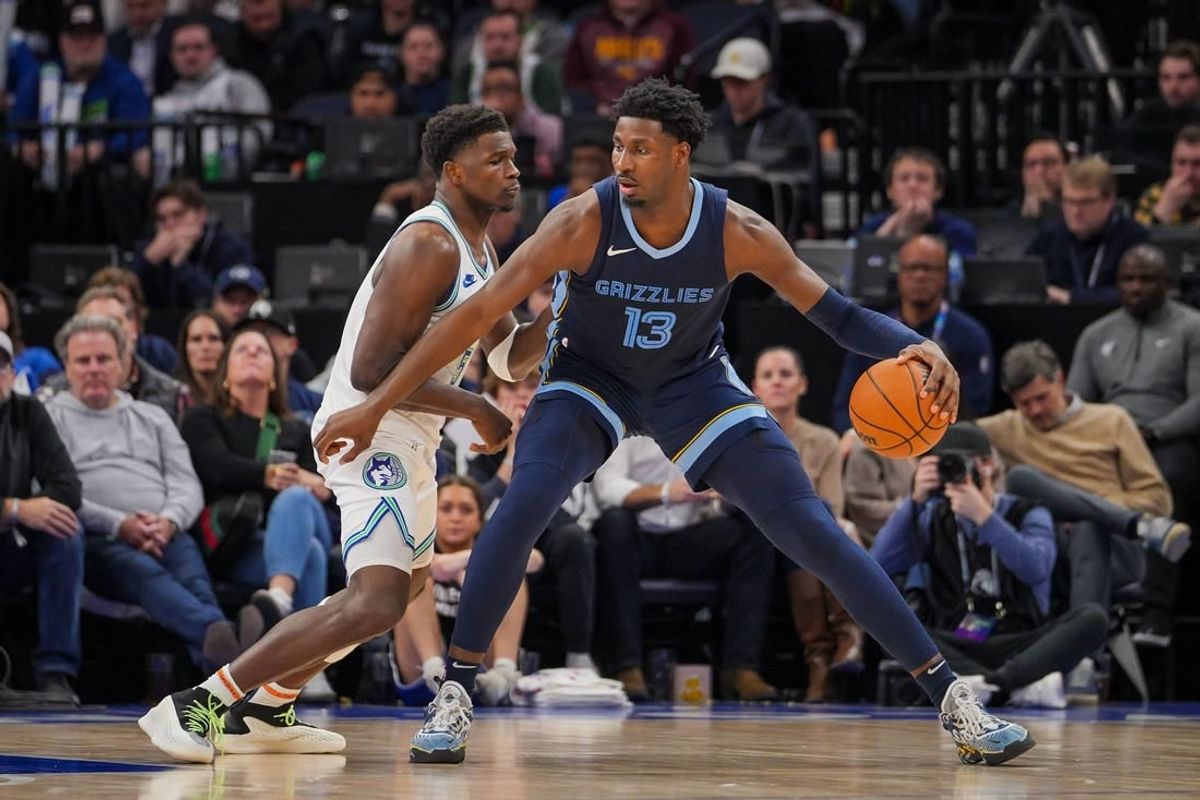 Jan 18, 2024; Minneapolis, Minnesota, USA; Minnesota Timberwolves guard Anthony Edwards (5) defends the Memphis Grizzlies forward Jaren Jackson Jr. (13) in the second quarter at Target Center.