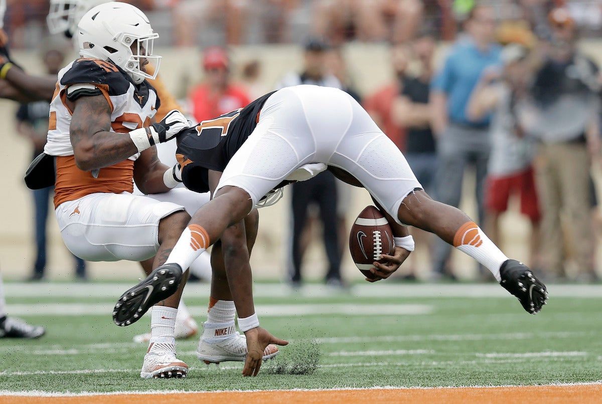 Texas quarterback Tyrone Swoopes gets sacked by Texas defensive end Quincy Vasser in the spring game. Via  [object Object] .