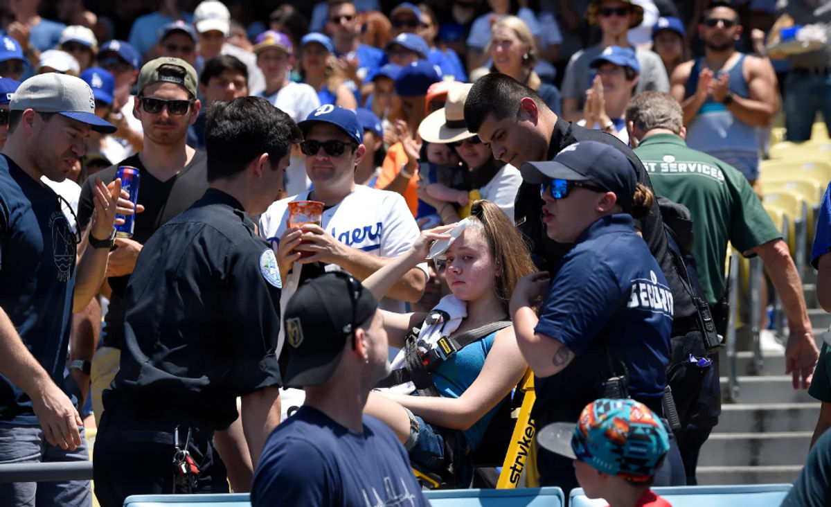 A young fan is carted away after being hit with a foul ball hit by Los Angeles Dodgers’ Cody Bellinger during the first inning of a baseball game against the Colorado Rockies, Sunday, June 23, 2019, in Los Angeles.