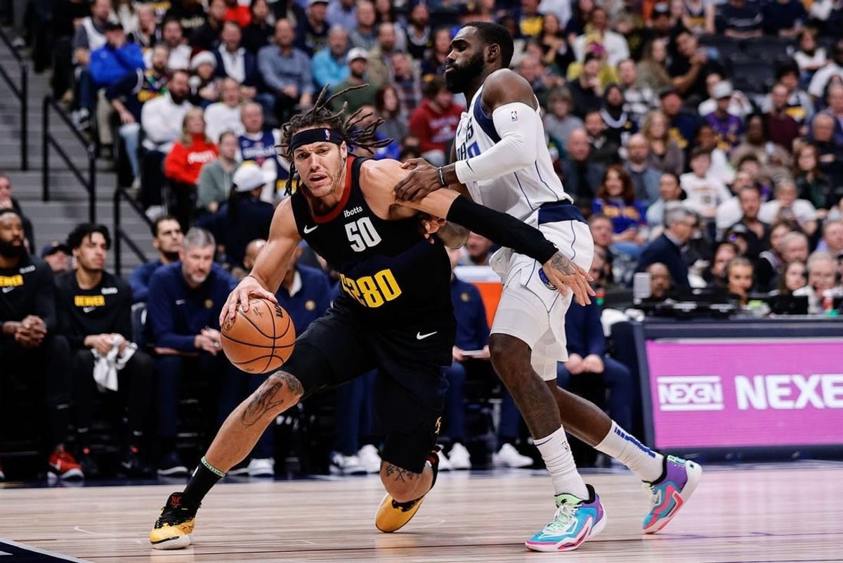Dec 18, 2023; Denver, Colorado, USA; Denver Nuggets forward Aaron Gordon (50) controls the ball as Dallas Mavericks forward Tim Hardaway Jr. (10) guards in the second quarter at Ball Arena.