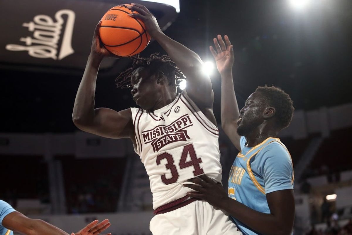 Dec 3, 2023; Starkville, Mississippi, USA; Mississippi State Bulldogs center Gai Chol (34) collects a rebound over Southern Jaguars forward Delang Muon (35) during the first half at Humphrey Coliseum.