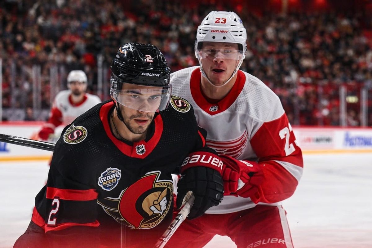 Nov 16, 2023; Stockholm, SWE; Ottawa Senators defenseman Artem Zub (2) and Detroit Red Wings left wing Lucas Raymond (23) battle for position during a Global Series NHL hockey game at Avicii Arena.