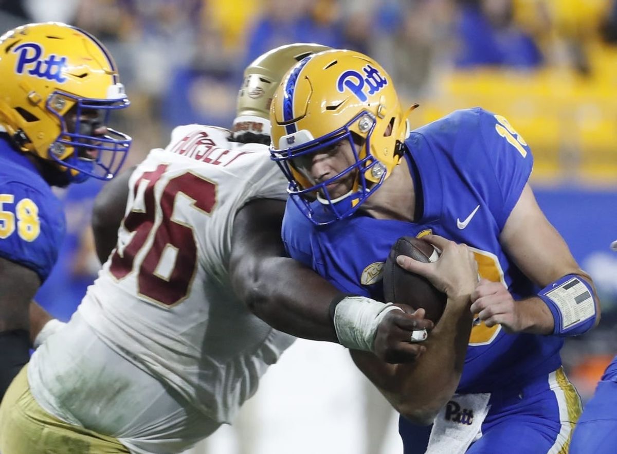 Nov 16, 2023; Pittsburgh, Pennsylvania, USA; Pittsburgh Panthers quarterback Nate Yarnell (19) carries the ball against Boston College Eagles defensive tackle Cam Horsley (96) during the second quarter at Acrisure Stadium.