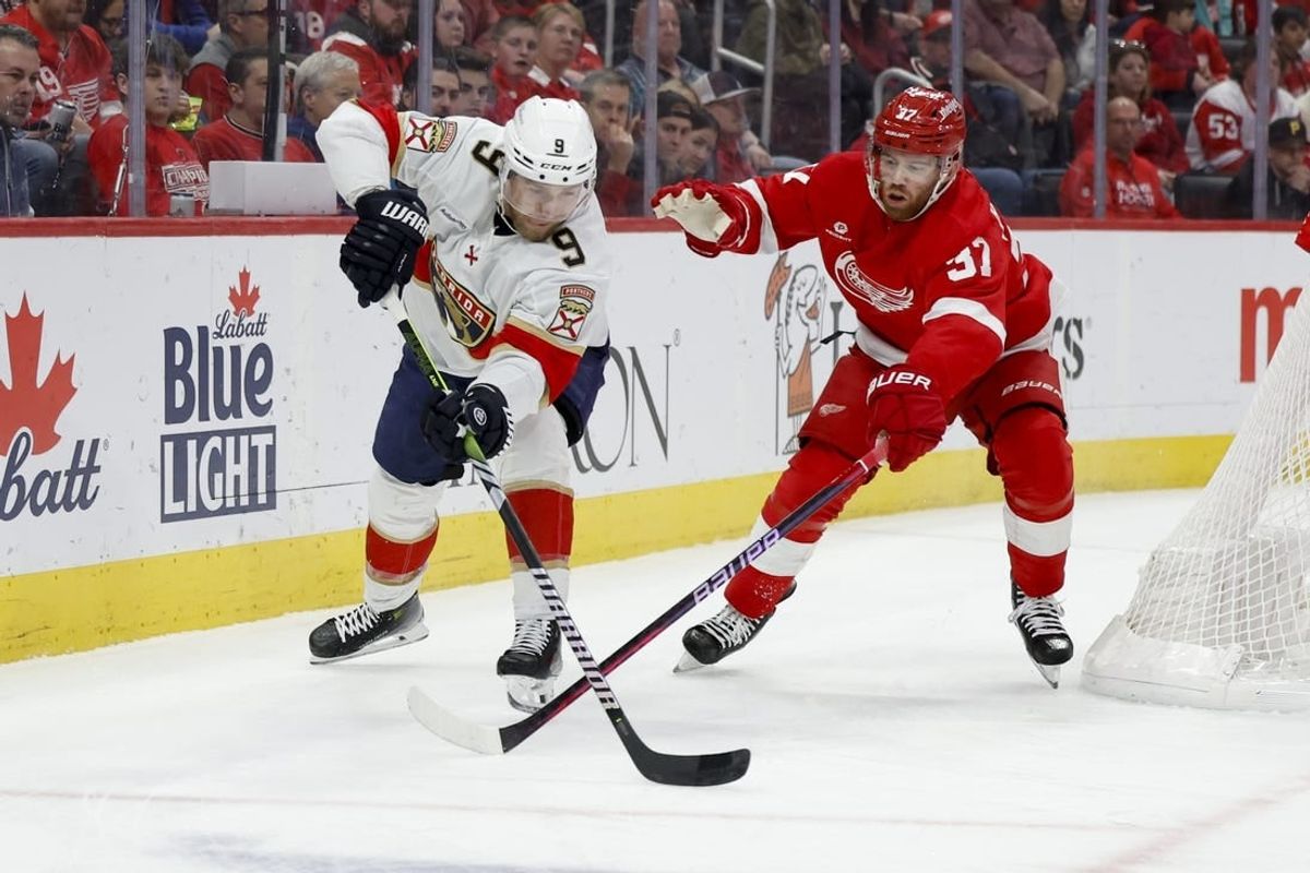Mar 2, 2024; Detroit, Michigan, USA; Florida Panthers center Sam Bennett (9) and Detroit Red Wings left wing J.T. Compher (37) battle for the puck in the first period at Little Caesars Arena.