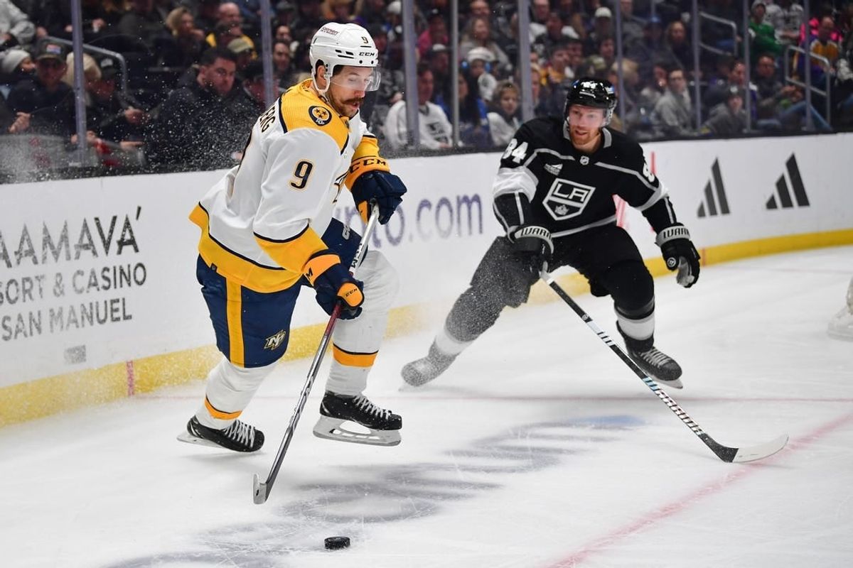 Feb 22, 2024; Los Angeles, California, USA; Nashville Predators left wing Filip Forsberg (9) controls the puck against Los Angeles Kings defenseman Vladislav Gavrikov (84) during the first period at Crypto.com Arena.