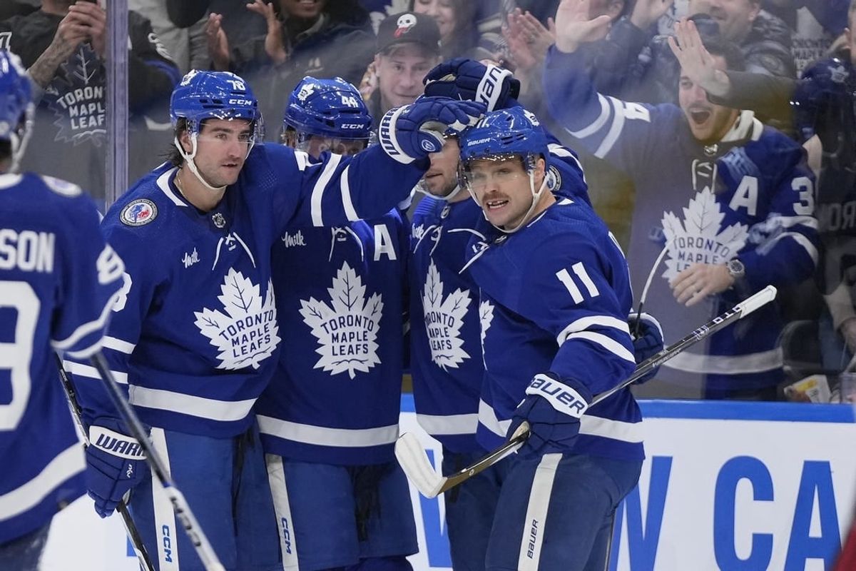 Nov 10, 2023; Toronto, Ontario, CAN; Toronto Maple Leafs defenseman TJ Brodie (78) and forward Max Domi (11) celebrate a goal by forward Calle Jarnkrok (not pictured) against the Calgary Flames during the first period at Scotiabank Arena.