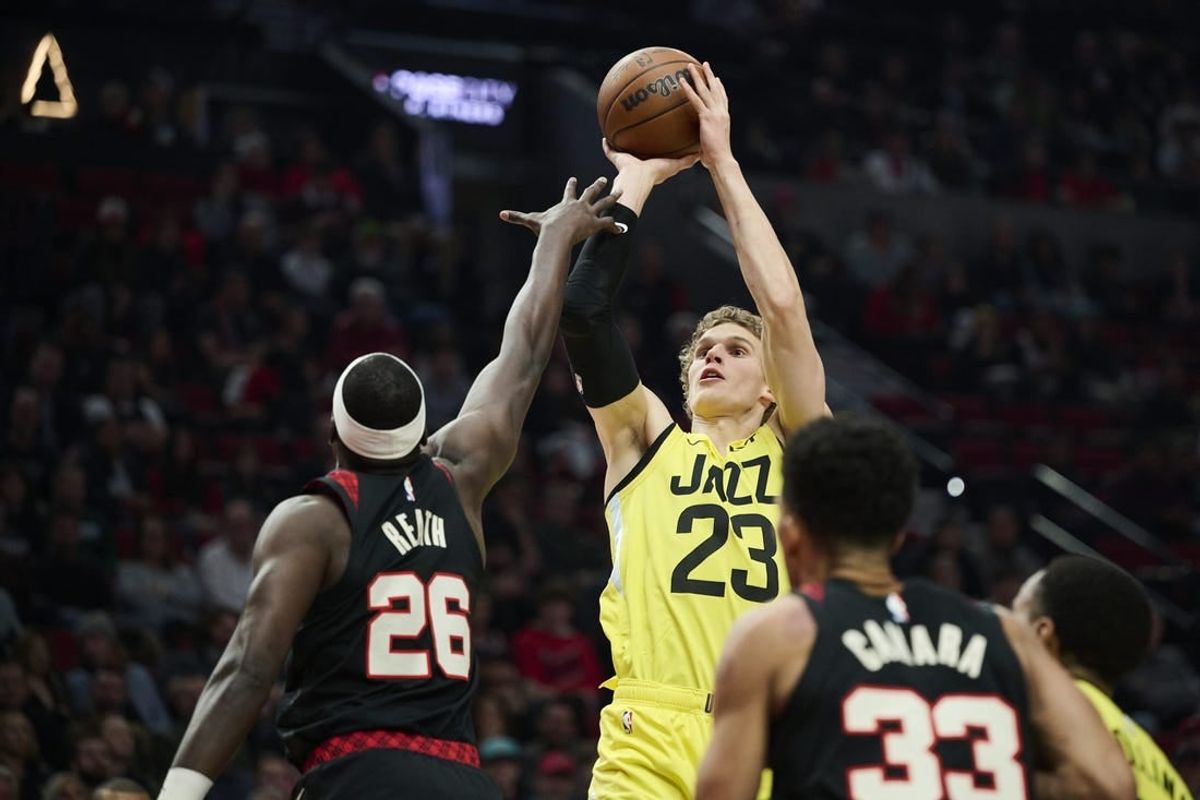 Nov 22, 2023; Portland, Oregon, USA; Utah Jazz forward Lauri Markkanen (23) shoots a jump shot during the first half against Portland Trail Blazers center Duop Reath (26) at Moda Center.