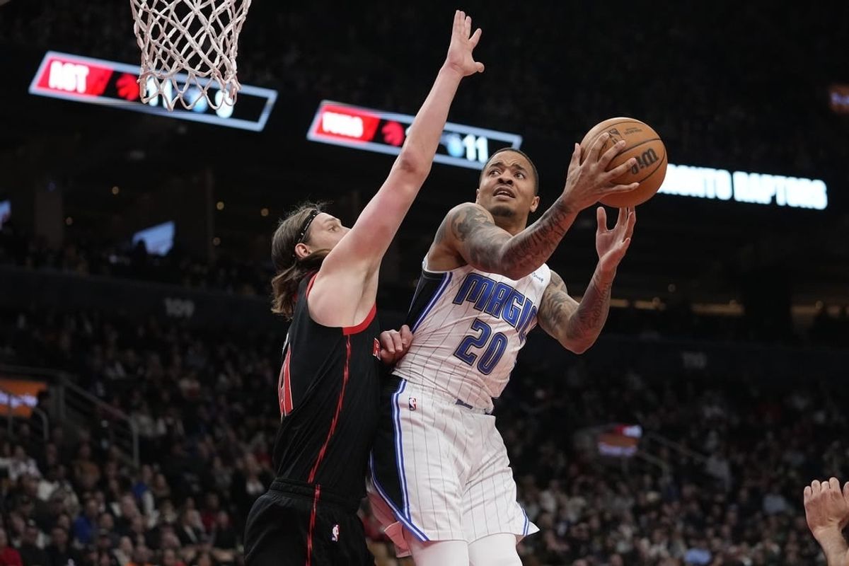 Mar 15, 2024; Toronto, Ontario, CAN; Toronto Raptors forward Kelly Olynyk (41) defends against Orlando Magic guard Markelle Fultz (20) during the first half at Scotiabank Arena.