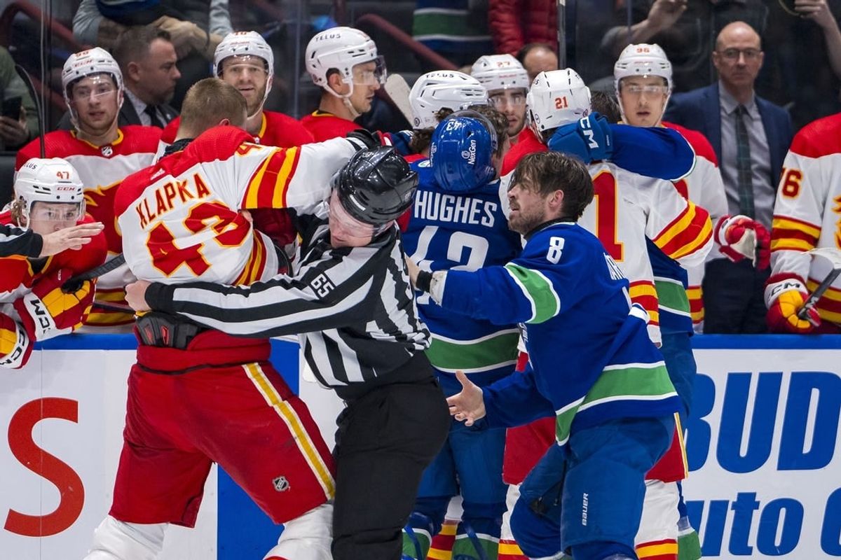 Apr 16, 2024; Vancouver, British Columbia, CAN; Calgary Flames forward Adam Klapka (43) wrestles with Vancouver Canucks forward Conor Garland (8) in the second period at Rogers Arena.