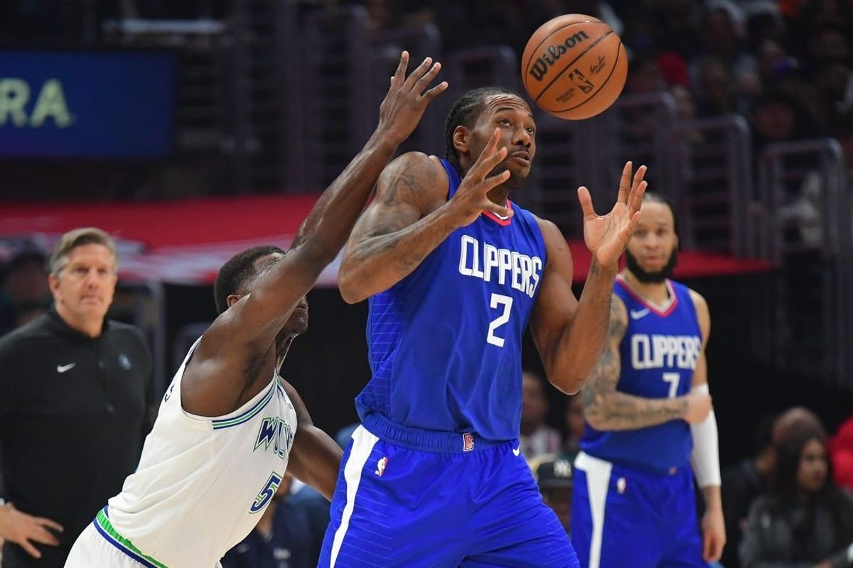 Mar 12, 2024; Los Angeles, California, USA; Los Angeles Clippers forward Kawhi Leonard (2) loses the ball against Minnesota Timberwolves guard Anthony Edwards (5) during the first half at Crypto.com Arena.